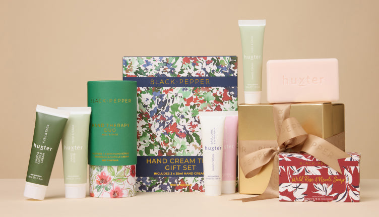 Collection of hand creams, soap and gift sets on a beige background